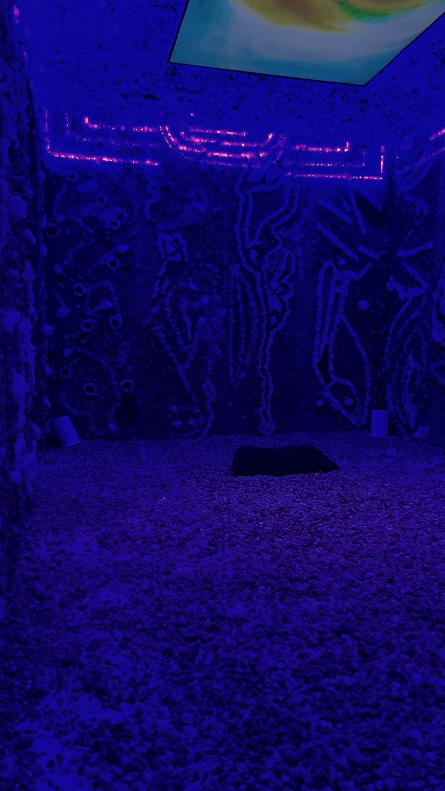 The same Crystal Chamber in cool blue light, showing hand-set crystal patterns on the walls